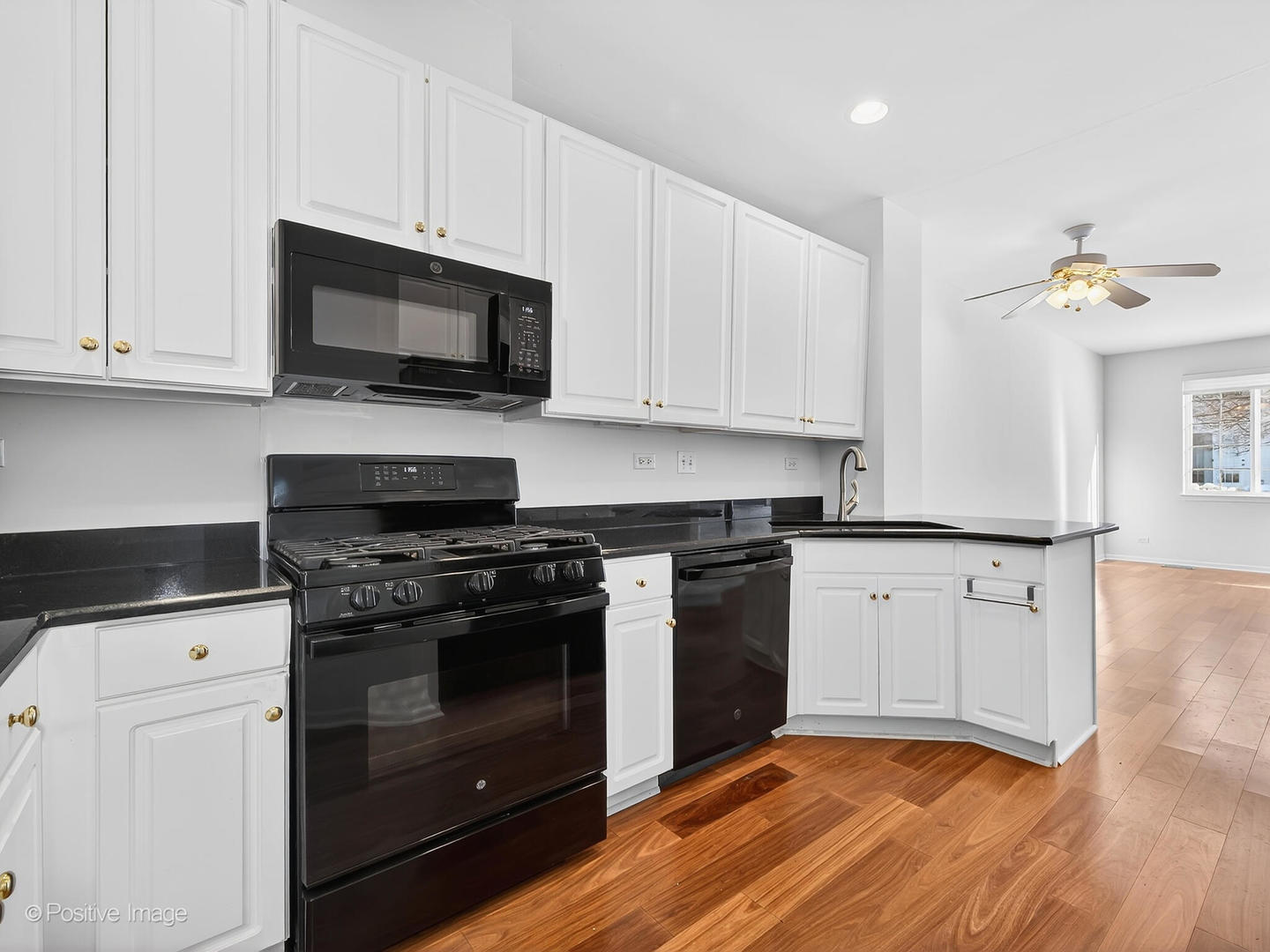 31104 Carpenter Court Warrenville, IL 60555 - Photo 15 of 32 a kitchen with stainless steel appliances granite countertop a stove a microwave and white cabinets