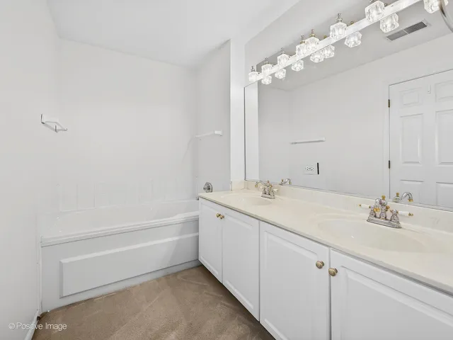 a bathroom with a sink a large mirror and a bathtub with shower