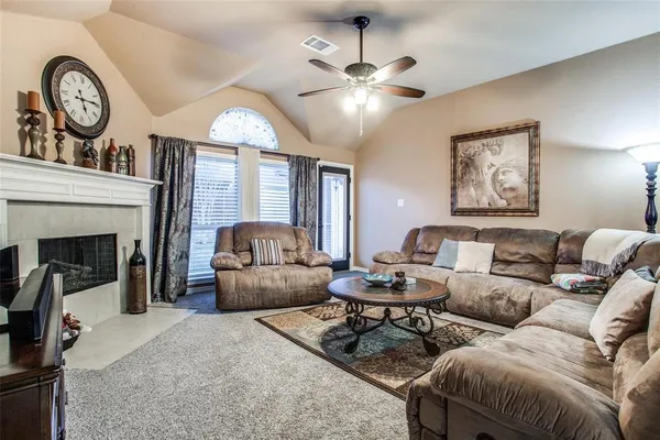 a living room with furniture a clock and a fireplace