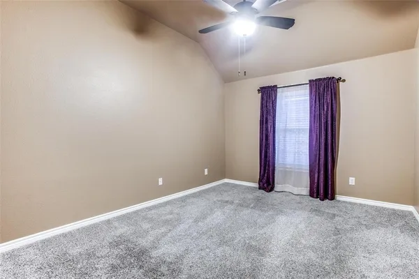 an empty room with closet and chandelier fan