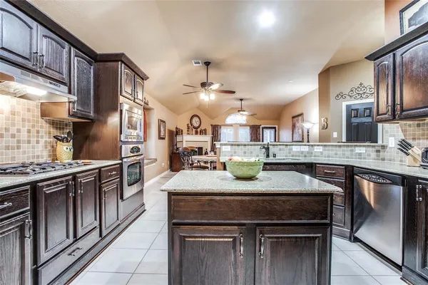 a kitchen with stainless steel appliances granite countertop a sink and stove