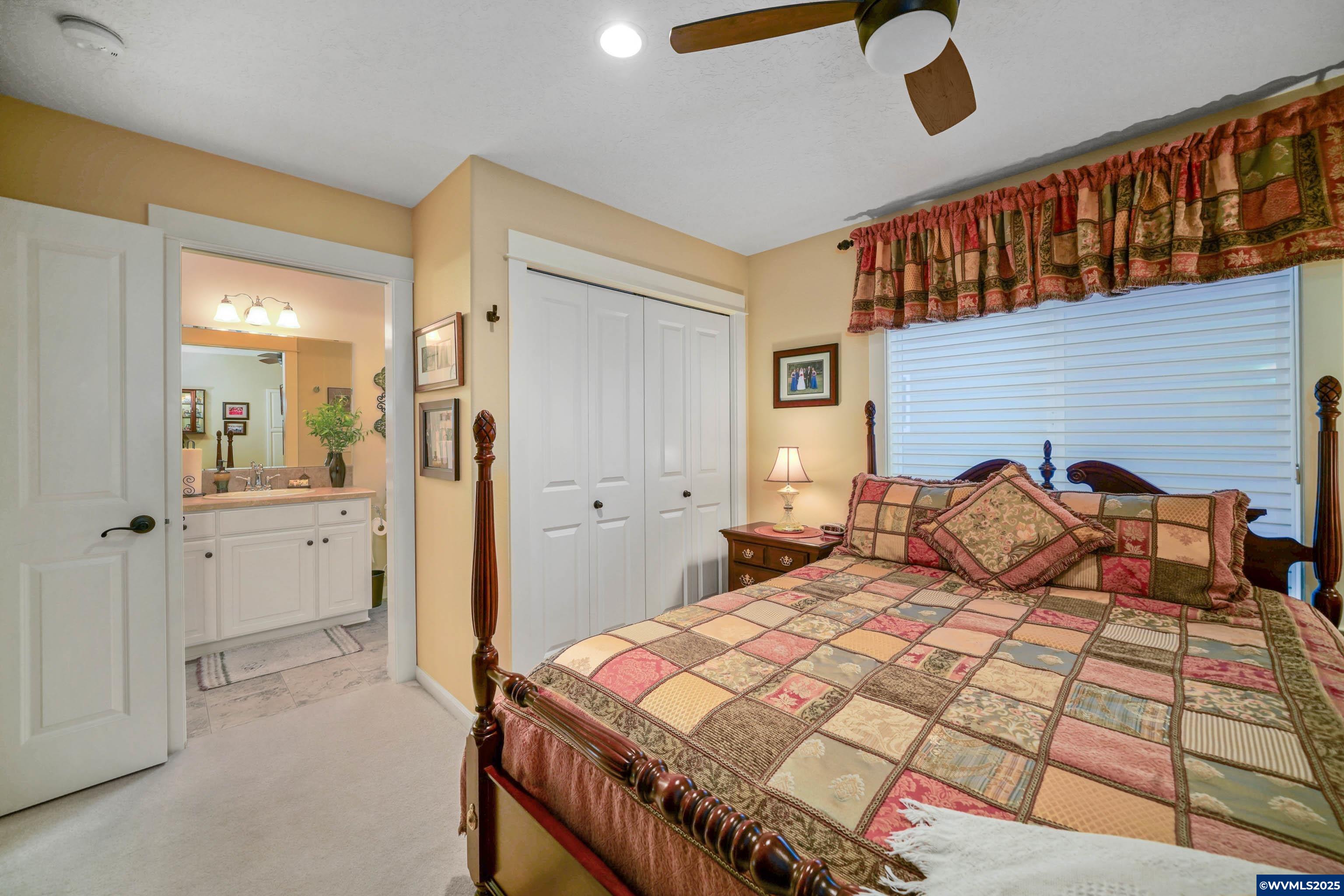 2224 Southeast Rhododendron Avenue Dallas, OR 97338 - Photo 11 of 38 a bedroom with a bed and a walk in closet