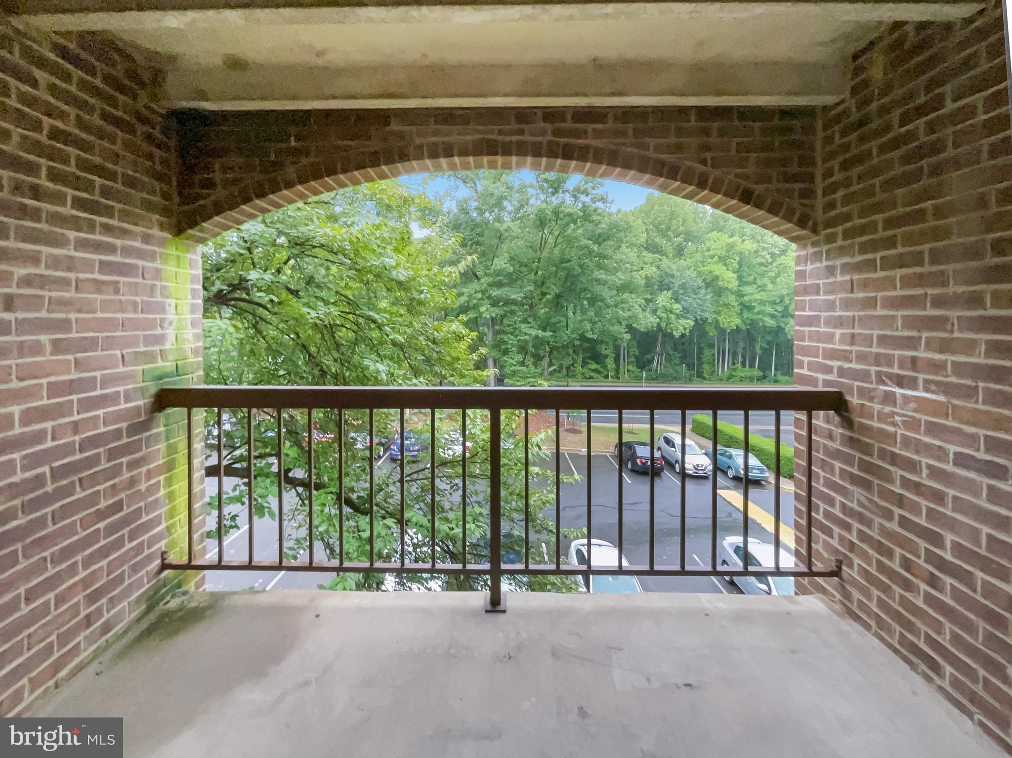 11204 Chestnut Grove Square, Unit 206 Reston, VA 20190 - Photo 17 of 18 a view of a room with a floor to ceiling window and an outdoor view