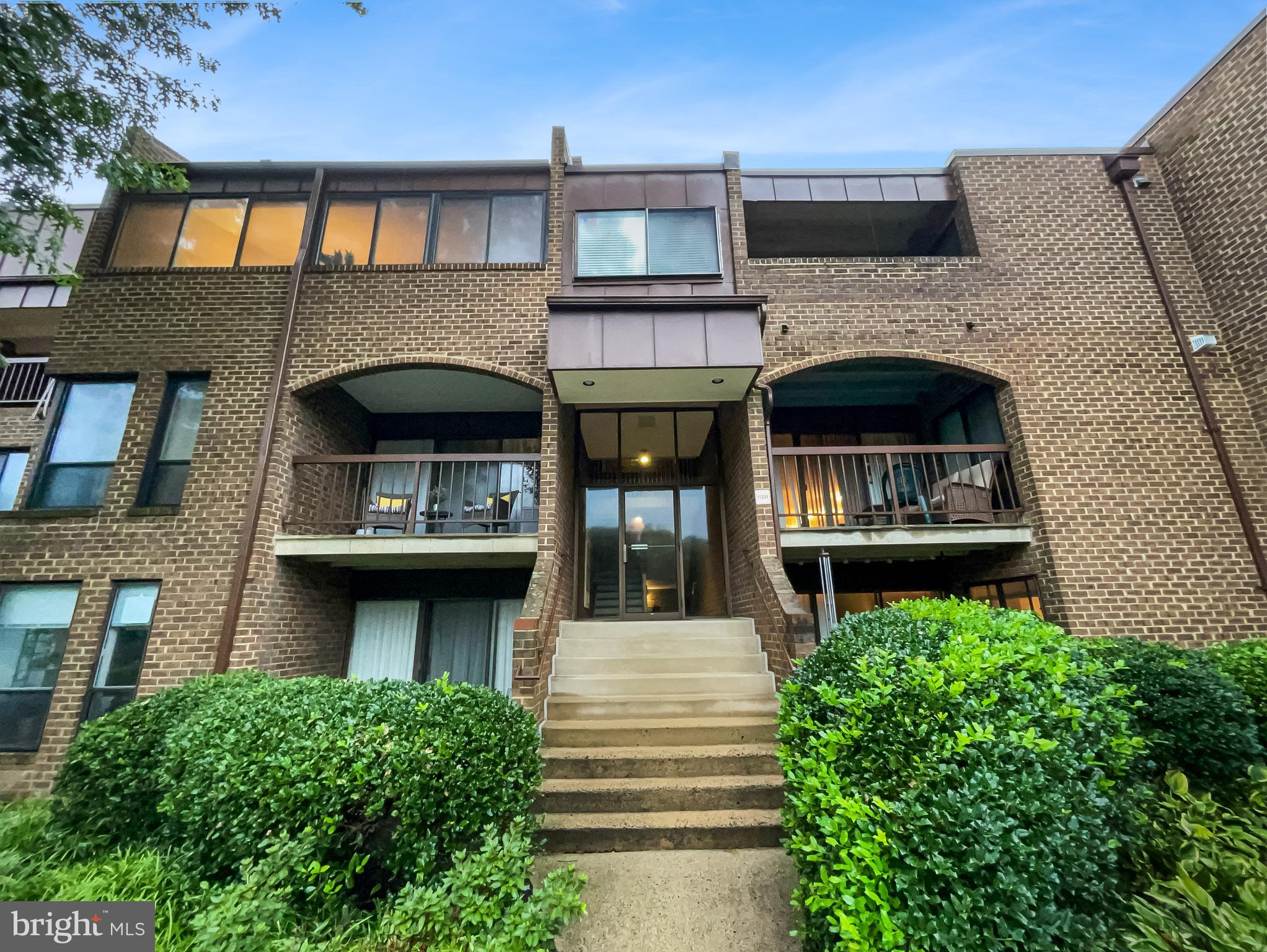 11204 Chestnut Grove Square, Unit 206 Reston, VA 20190 - Photo 5 of 18 a view of building with garden