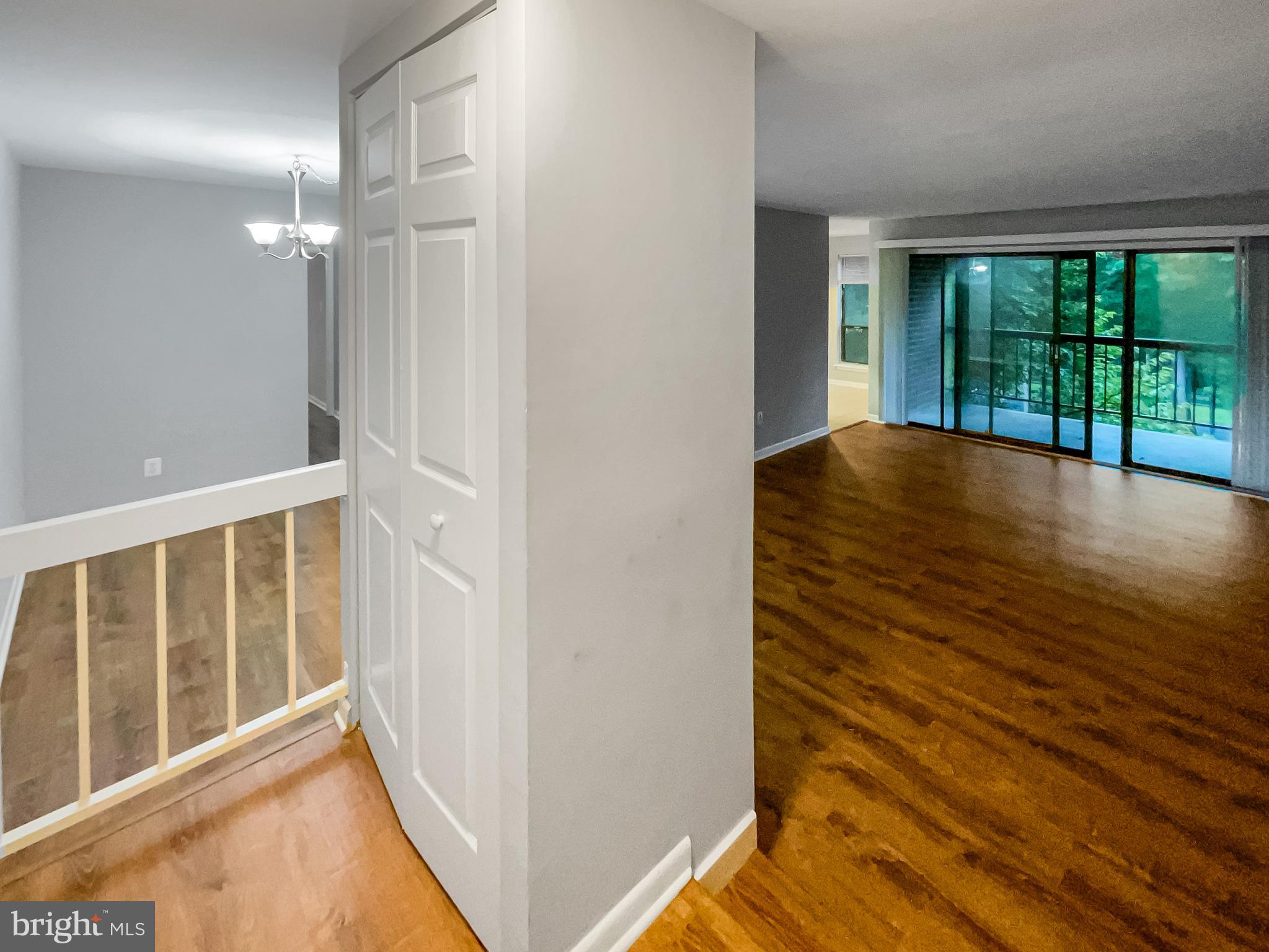 11204 Chestnut Grove Square, Unit 206 Reston, VA 20190 - Photo 7 of 18 a view of an empty room with wooden floor and a window