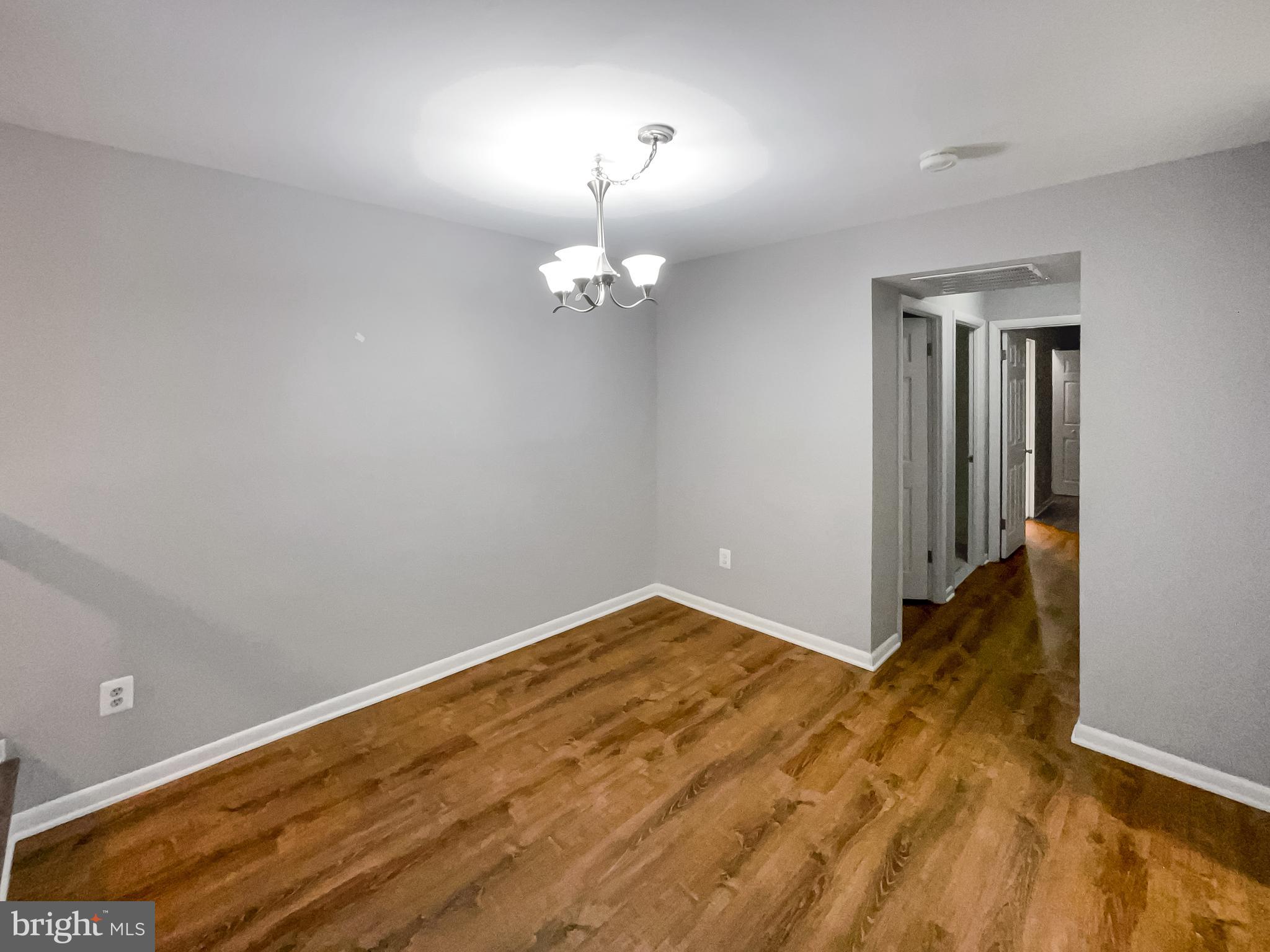 11204 Chestnut Grove Square, Unit 206 Reston, VA 20190 - Photo 8 of 18 wooden floor in an empty room