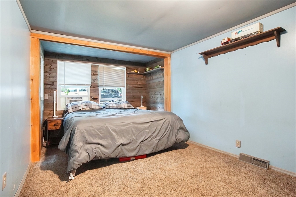 7 Davidson Road Holland, MA 01521 - Photo 17 of 32 a bed sitting in a bedroom next to a window