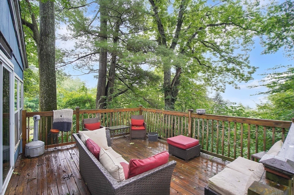 7 Davidson Road Holland, MA 01521 - Photo 22 of 32 a view of a deck with couches table and chairs with wooden fence and plants