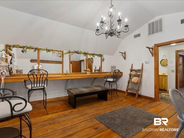 4650 Wiggins Lane Wilmer, AL 36587 - Photo 47 of 66 Living area featuring wood-type flooring, a chandelier, and high vaulted ceiling