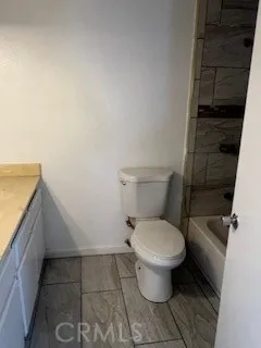 a toilet sitting in a bathroom next to a sink