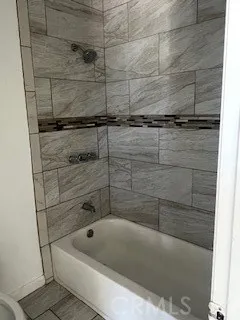 a bath tub sitting next to a shower