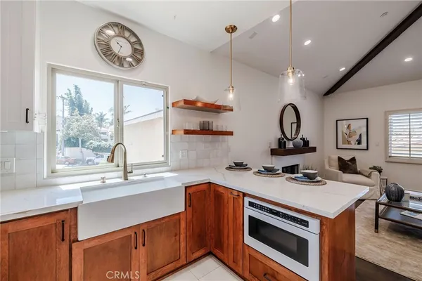 a kitchen with a stove a sink and a window