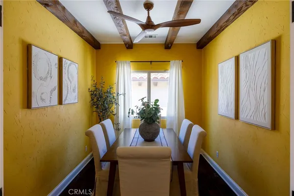 a dining room with furniture and window