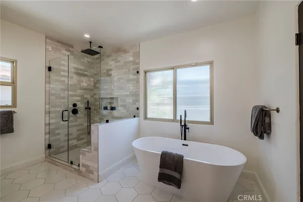 a bathroom with double vanity sinks and a mirror