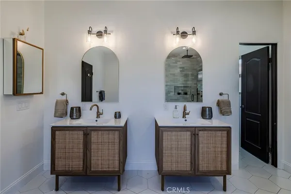 a spacious bathroom with a double vanity sink and a mirror