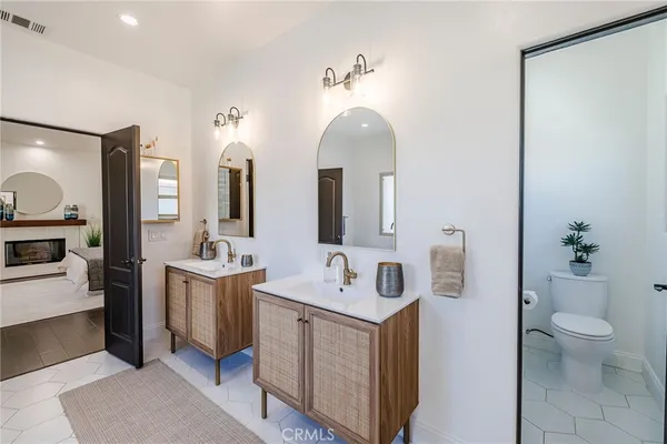 a spacious bathroom with a double vanity sink and a mirror