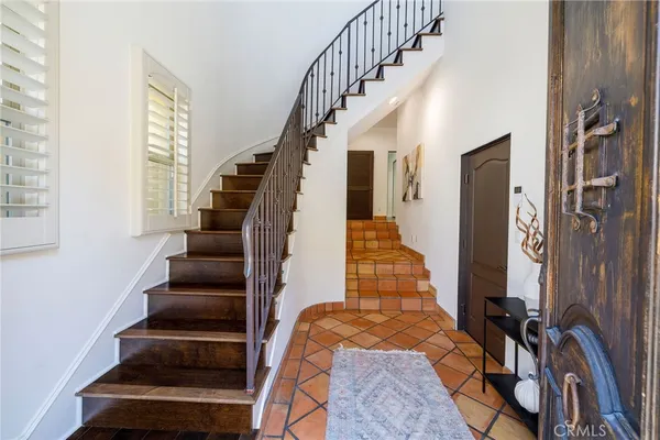 a view of entryway with wooden floor and windows
