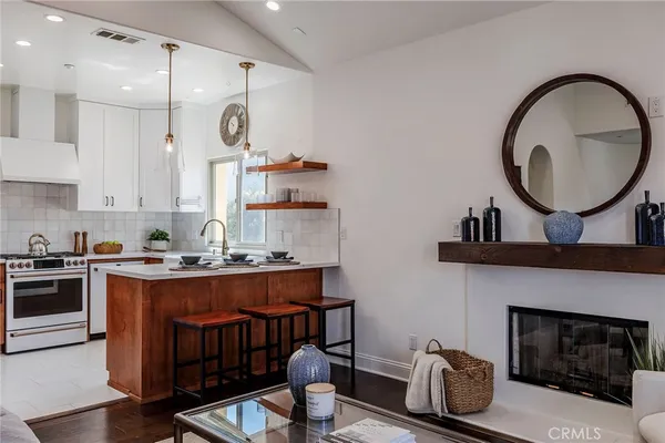 a kitchen with sink a stove and cabinets