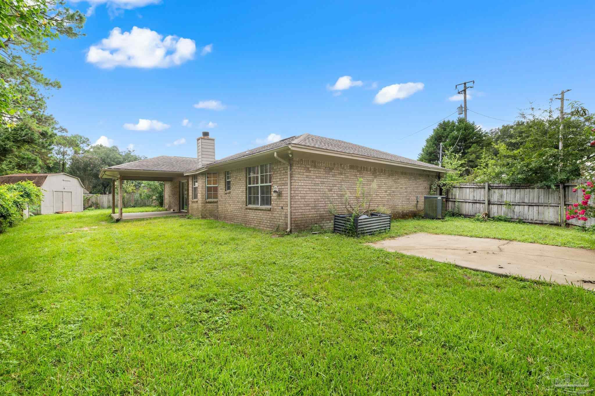 1203 Brook Bend Road Pensacola, FL 32506 - Photo 16 of 17 a front view of a house with garden
