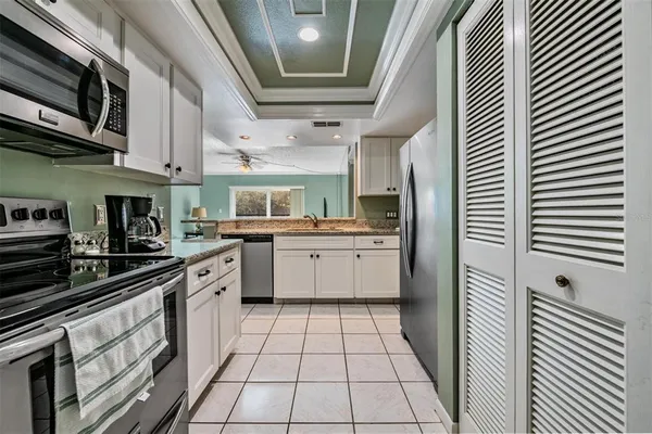 a kitchen with stainless steel appliances granite countertop a sink and cabinets