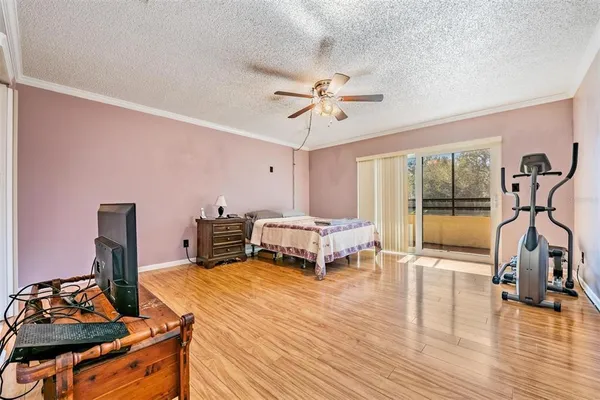 a bedroom with furniture and a wooden floor
