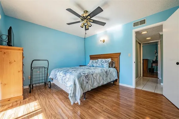 a bedroom with a bed and a ceiling fan