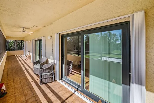 a living room with a floor to ceiling window and furniture
