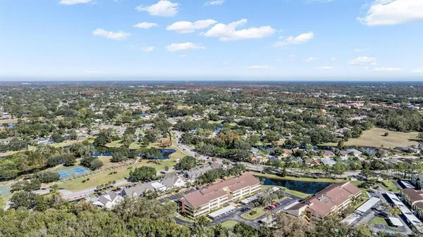 an aerial view of a residential houses with city view