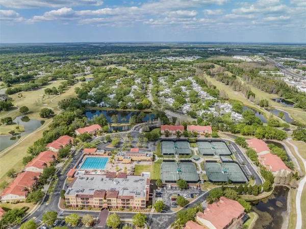 an aerial view of residential houses and car parked