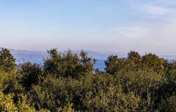 a bathroom with a tub a sink and a large mirror