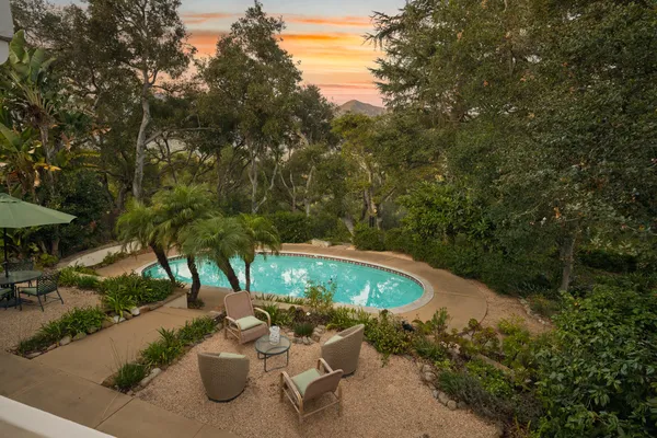 a view of a backyard with sitting area