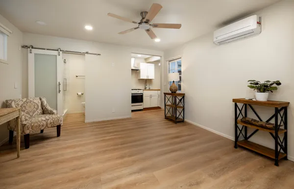 a view of a patio with table and chairs with wooden floor and fence