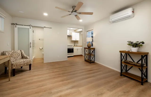 a view of a patio with table and chairs with wooden floor and fence