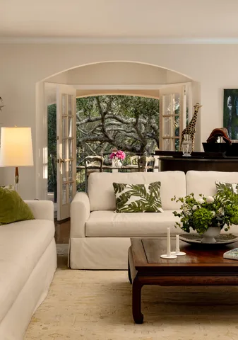 a living room with furniture and a potted plant