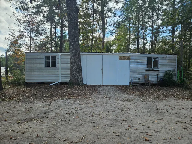 a wooden bench sitting in front of a building