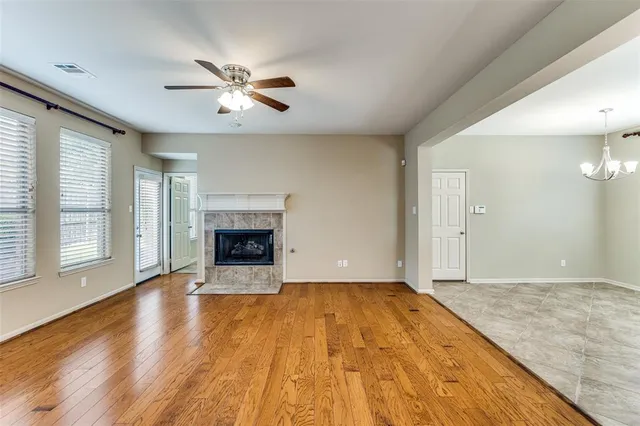 a view of an empty room with a fireplace and a window