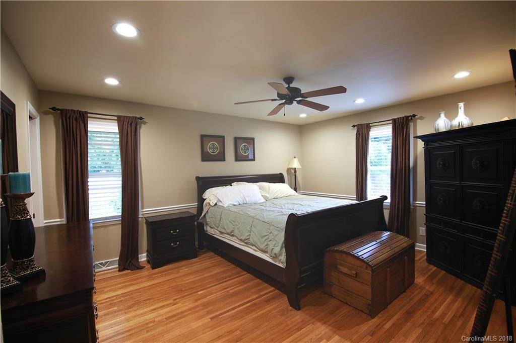5708 Old Monroe Road Indian Trail, NC 28079 - Photo 12 of 26 a spacious bedroom with a bed and a chandelier