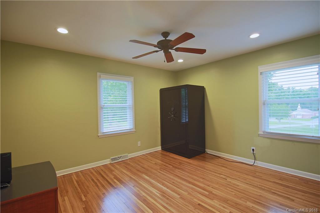 5708 Old Monroe Road Indian Trail, NC 28079 - Photo 14 of 26 a view of empty room with wooden floor and fan