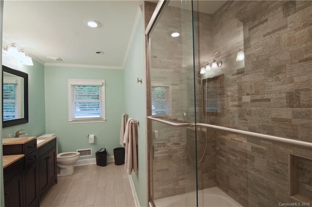 5708 Old Monroe Road Indian Trail, NC 28079 - Photo 17 of 26 a bathroom with a granite countertop sink a toilet and shower