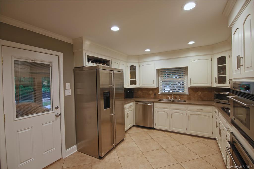 5708 Old Monroe Road Indian Trail, NC 28079 - Photo 22 of 26 a kitchen with stainless steel appliances granite countertop a refrigerator and a sink