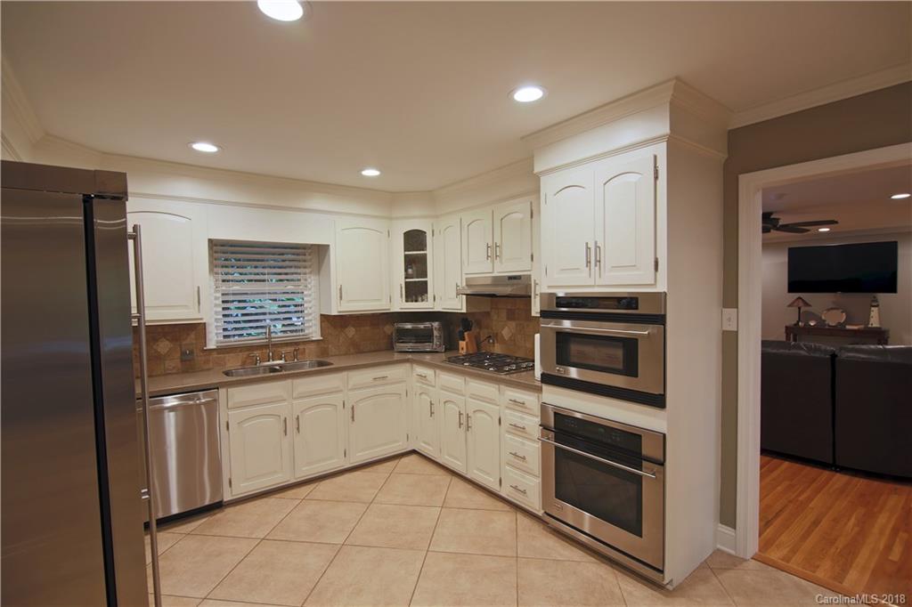 5708 Old Monroe Road Indian Trail, NC 28079 - Photo 23 of 26 a kitchen with white cabinets and appliances