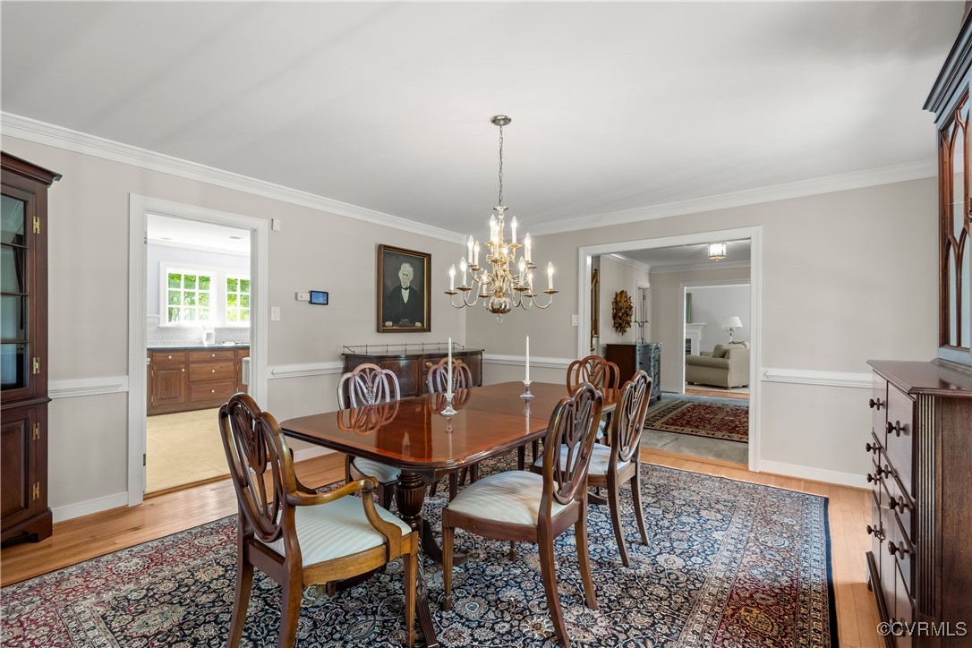 2410 Kentford Road Midlothian, VA 23113 - Photo 15 of 36 a dining room with furniture a chandelier and wooden floor
