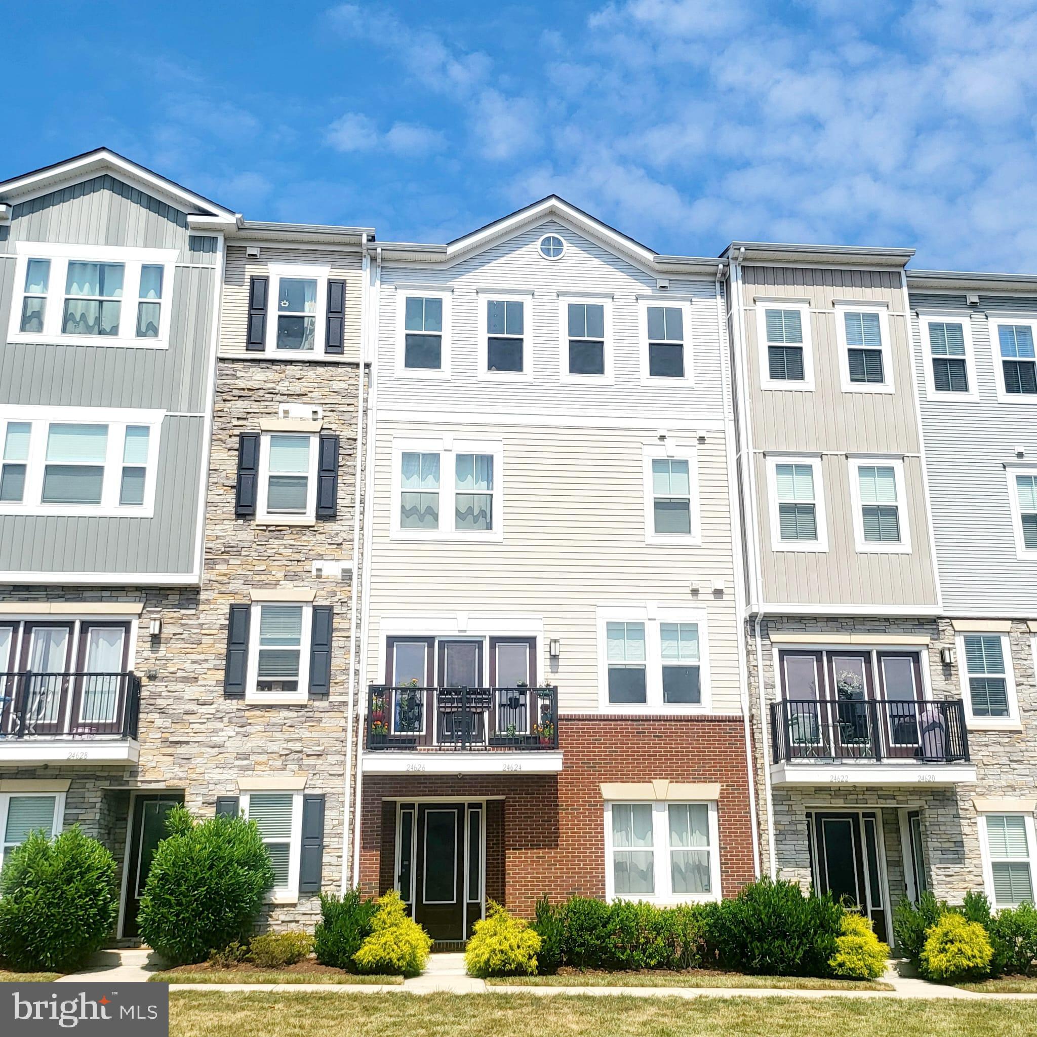 a front view of a building with a garden
