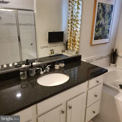 a bathroom with a sink double vanity and a mirror