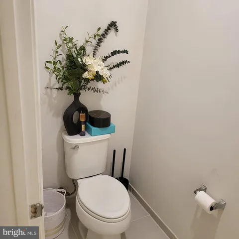 a white toilet sitting next to a shower