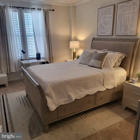 a bedroom with a bed and window