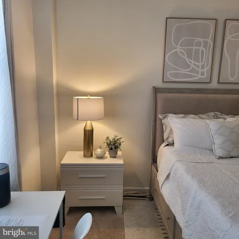 a bedroom with a bed and cabinet