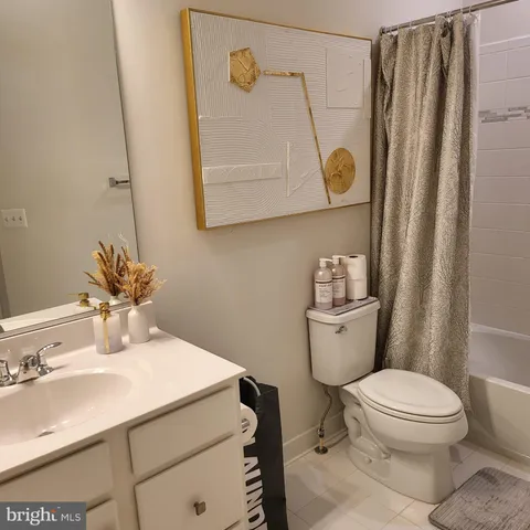 a bathroom with a sink a toilet and shower curtain