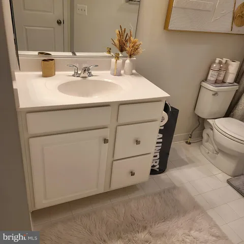 a bathroom with a sink toilet and mirror