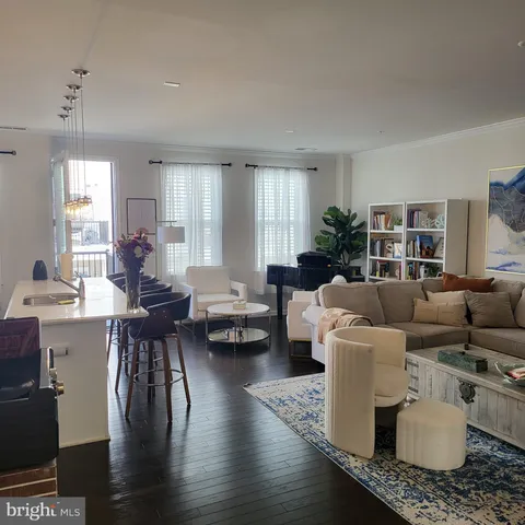 a living room with furniture wooden floor and a table